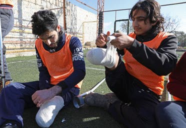 Syrian amputees who were injured in the war warm up for a football match organised by a centre for physical therapy in Idlib, the last province in the country outside government control, on January 15, 2018