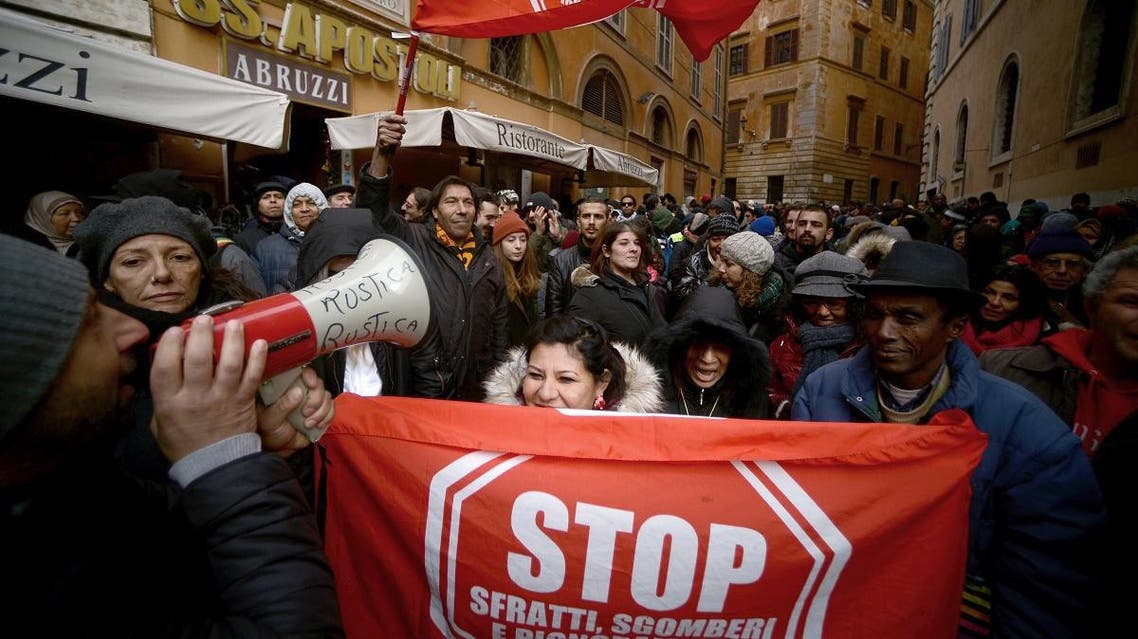 Members of the movement for the Struggle for Housing, migrants and evicted people demonstrate against the unseen Italian far right Lega Nord party leader Matteo Salvini. (AFP)
