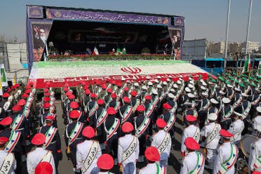 Iranian President Hassan Rouhani gestures as members of Iranian armed forces take part in a rally in Tehran, on February 11, 2018. (Reuters)
