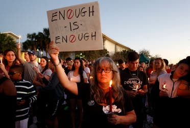 Mourners stand during a candlelight vigil for the victims of Marjory Stoneman Douglas High School shooting in Parkland, Florida on February 15, 2018. (AFP)