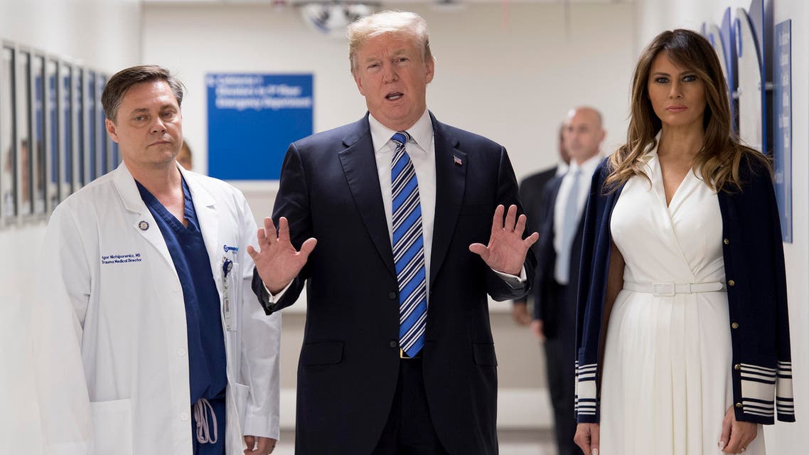 US President Donald Trump speaks with doctor Igor Nichiporenko (L) and First Lady Melania Trump while visiting first responders at Broward Health North hospital Pompano Beach, Florida, on February 16, 2018. US President Donald Trump and First Lady Melania Trump visited a Florida hospital to offer their respects to the victims of a mass shooting that claimed 17 lives at a nearby high school.