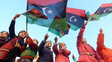 Libyan children wave their country's national flags as they celebrate in Tripoli's Martyrs' Square on February 16, 2018. (AFP)