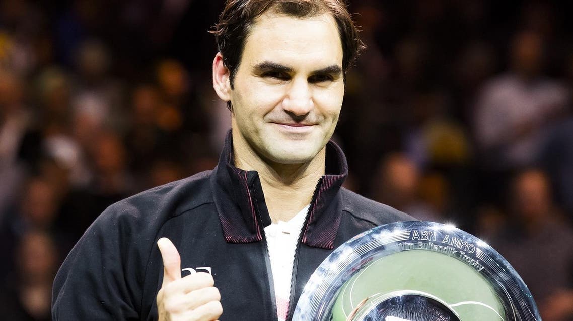 Switzerland’s Roger Federer holds his trophy after winning the final match against Bulgary’s Grigor Dimitrov at the ABN AMRO World Tennis Tournament in Rotterdam, on February 18, 2018. (AFP)