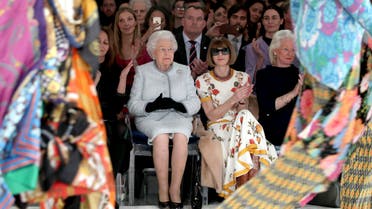 Britain's Queen Elizabeth, second left, sits next to fashion editor Anna Wintour, third left, and Caroline Rush, chief executive of the British Fashion Council (BFC), left, as they view Richard Quinn's runway show before presenting him with the inaugural Queen Elizabeth II Award for British Design, as she visits London Fashion Week's BFC Show Space in central London, Tuesday, Feb. 20, 2018. (Yui Mok/Pool photo via AP)