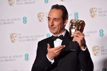French composer Alexandre Desplat poses with the award for Original Music for The Shape Of Water at BAFTA in London on February 18, 2018. (AFP)