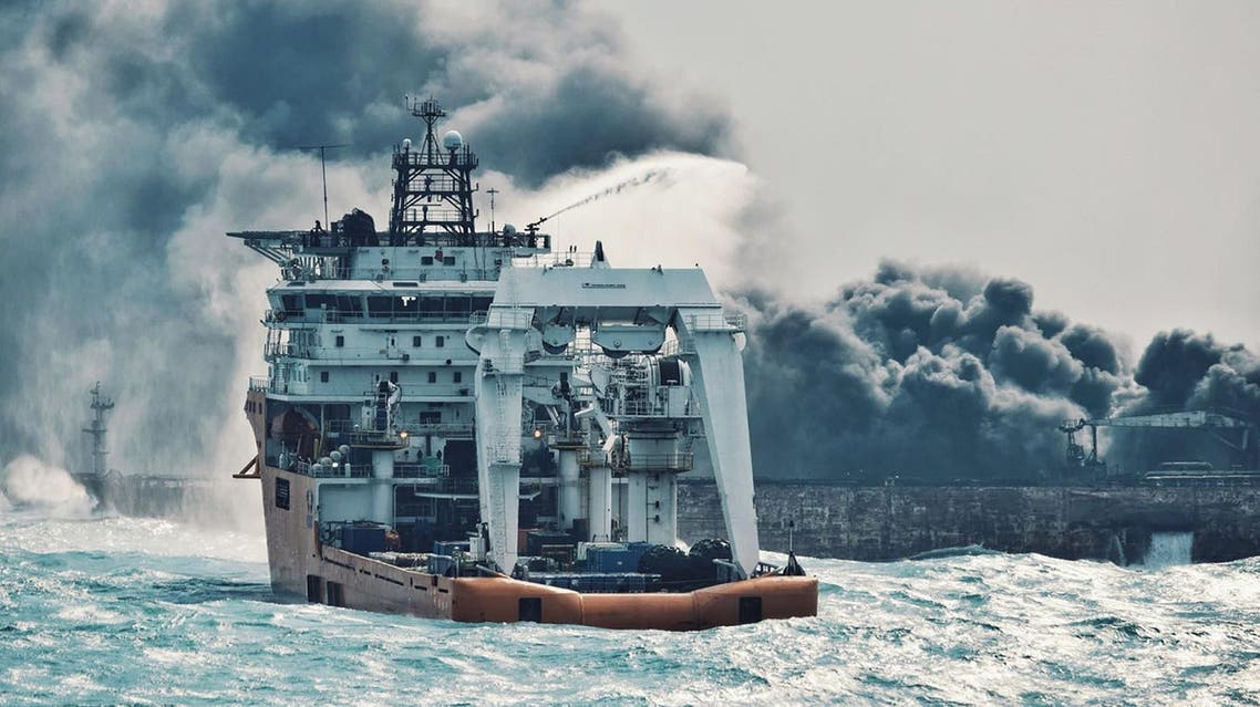 Chinese offshore supply ship spraying foam on Sanchi at sea off the coast of eastern China on January 10. (AFP)