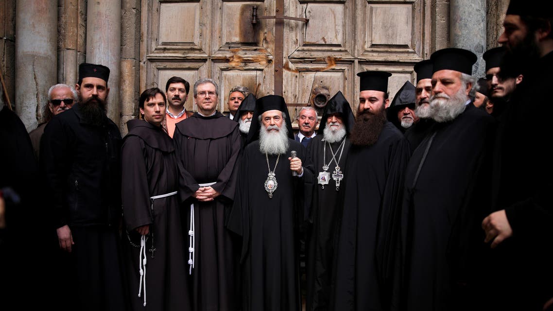 The Custodian of the Holy Land Father Francesco Patton (3rd L) and Greek Orthodox Patriarch of Jerusalem, Theophilos III (C) stand with other church leaders during a news conference in front of the closed doors of the Church of the Holy Sepulchre in Jerusalem's Old City. (Reuters)