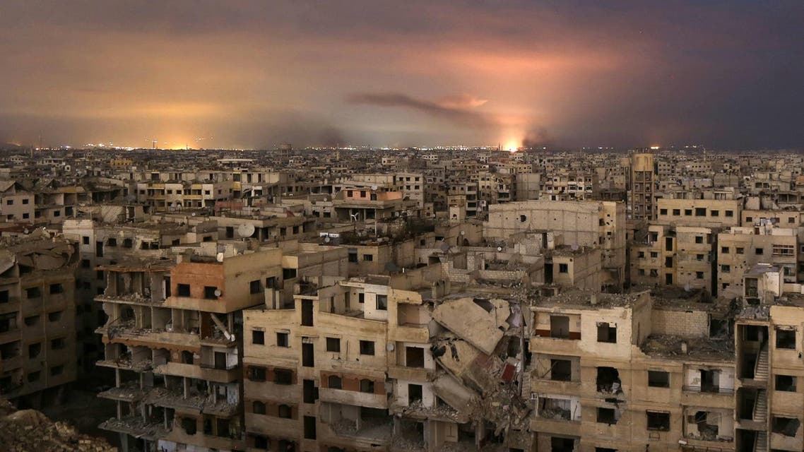 Smoke billows following a regime air strike on the besieged Eastern Ghouta region on the outskirts of the capital Damascus, late on February 23, 2018. (AFP)
