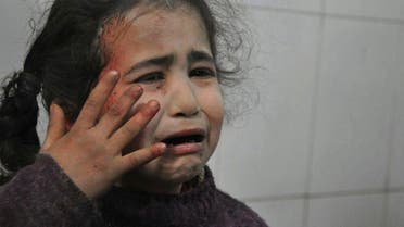 A Syrian young girl who was wounded during airstrikes and shelling by Syrian government forces, cries at a makeshift hospital, in Ghouta. (AP)