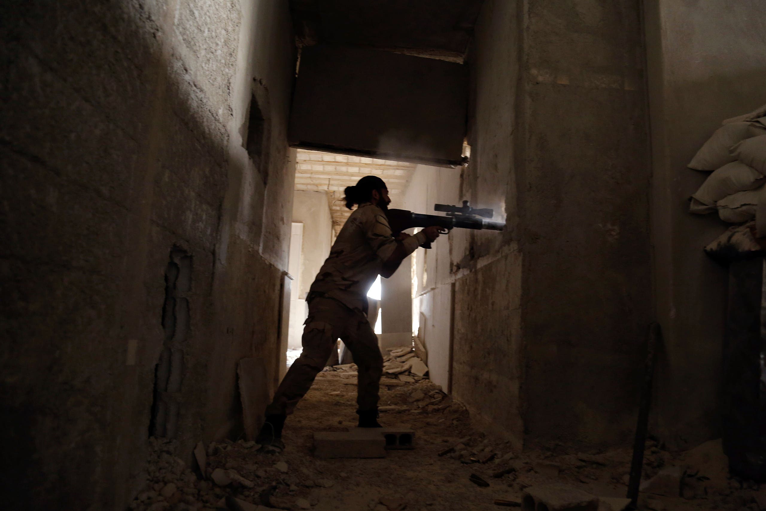 A Syrian rebel fighter fires a weapon in the eastern Ghouta area on July 17, 2017. (AFP)