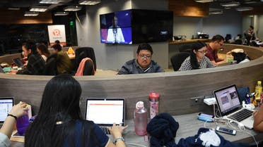 This file photo taken on January 15, 2018 shows employees of online portal Rappler working at the company's editorial office in Manila. (AFP)