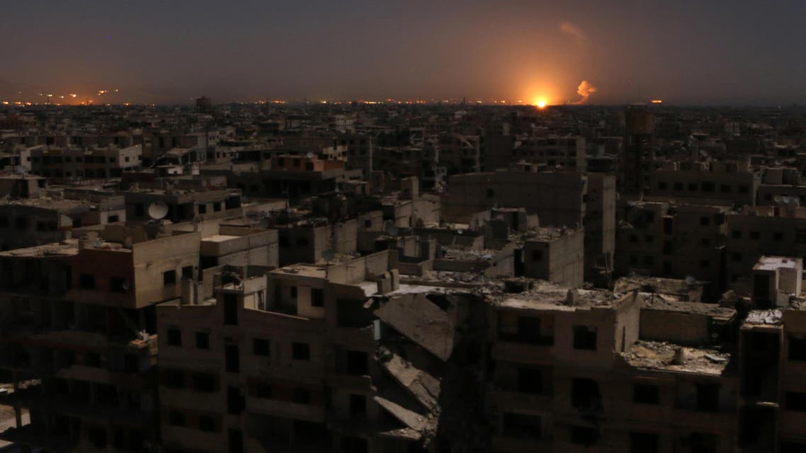Flames following a reported rocket attack is seen on the horizon in the rebel-held enclave of Eastern Ghouta on February 28, 2018. Mohammed EYAD / AFP