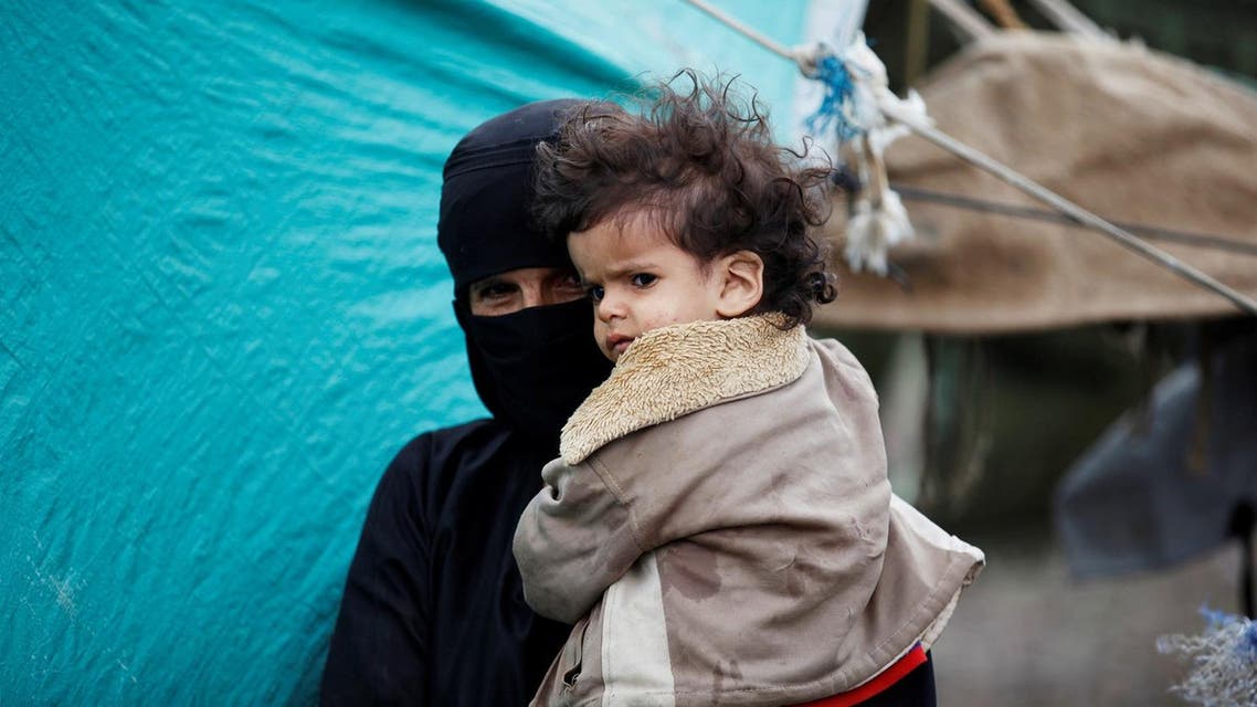 A woman holds her grandson at a camp for internally displaced people near Sanaa, Yemen, August 10, 2016. (Reuters)