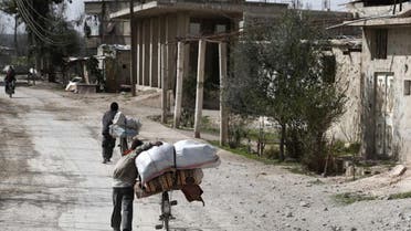 Syrians pack their belongings as they flee their home in the town of Utaya in the Syrian rebel enclave of Eastern Ghouta on March 1, 2018. (AFP)