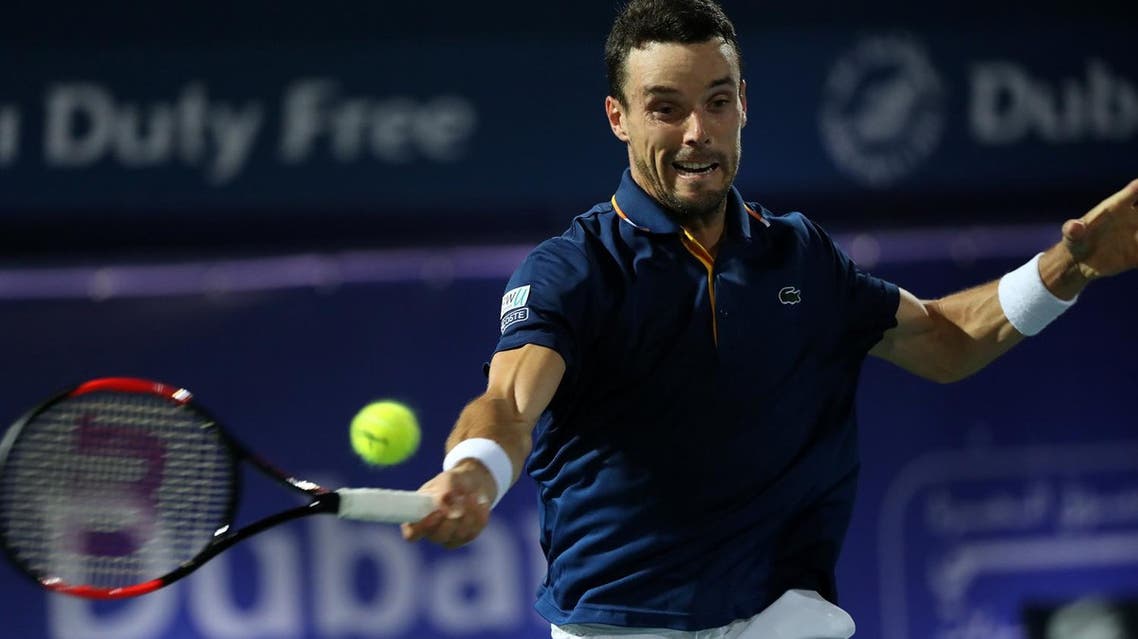 Spain’s Roberto Bautista Agut returns the ball to Lucas Pouille of France (unseen) during their final match in the 2018 ATP Dubai Duty Free Tennis Championships on March 3, 2018. (AFP)