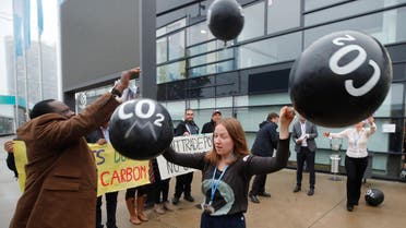 Activists protest against the carbon dioxide emissions trading in front of the World Congress Centre Bonn, the site of the COP23 UN Climate Change Conference, in Bonn, Germany, November 17, 2017. (Reuters)