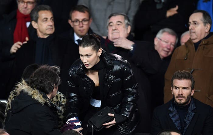 British former football players David Beckham (R) and US model Bella Hadid (C) attend the UEFA Champions League round of 16 second leg football match between Paris Saint-Germain (PSG) and Real Madrid on March 6, 2018, at the Parc des Princes stadium in Paris. (AFP)