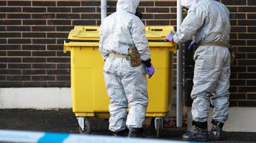 Soldiers wearing protective suits seal a bin at an ambulance station in Salisbury, Britain, on March 10, 2018. (Reuters)
