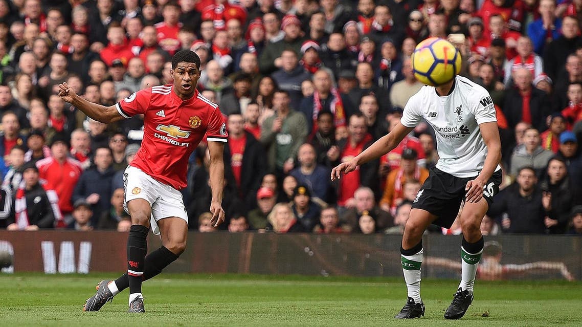 Manchester United's English striker Marcus Rashford (L) scores the opening goal against Liverpool in the Premier League on Saturday. (AFP)