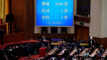 The results of the vote on a constitutional amendment lifting presidential term limits is seen on a giant screen, at the third plenary session of the National People's Congress (NPC) at the Great Hall of the People in Beijing, China March 11, 2018. REUTERS/Jason Lee