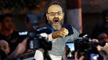 Ziad Itani shouts as he speaks with journalists after he was released by Lebanese authorities, at his house, in Beirut on March 13, 2018. (AP)