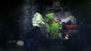 Members of the emergency services put on protective suits near to the grave of Luidmila Skripal, wife of former Russian intelligence agent Sergei Skripal, at the London Road Cemetery in Salisbury, Britain, March 10, 2018. (Reuters)
