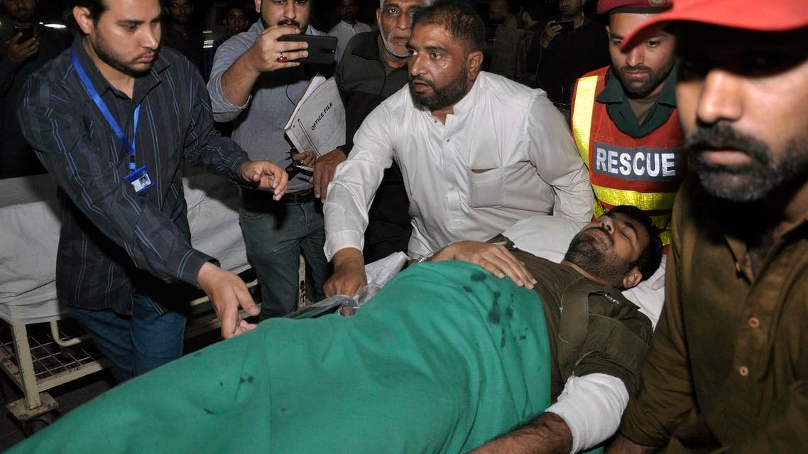 Volunteers rush a wounded police officer to a hospital in Lahore, Pakistan, Wednesday, on March 14, 2018. (AP)