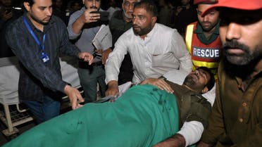 Volunteers rush a wounded police officer to a hospital in Lahore, Pakistan, Wednesday, on March 14, 2018.  (AP)