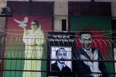 A poster of opposition Bangladesh Nationalist Party (BNP) leader, Khaleda Zia (L) is seen with her two sons late Arafat Rahman Koko (C) and Tarique Rahman (R) in front of BNP office in Dhaka on February 26, 2015. (AFP)