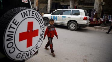 A Syrian child is seen walking near International Red Cross vehicle in the rebel-held city of Douma. (File photo: Reuters)