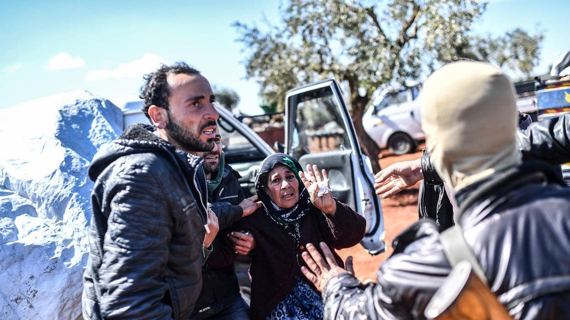 Turkish-backed Syrian opposition fighters (R) try to detain a young man (1st-L) as his mother (C) tries to stop them, ahead of crossing to the Turkish-backed Syrian rebels side at a check point in the village of Anab on March 17, 2018. (AFP)