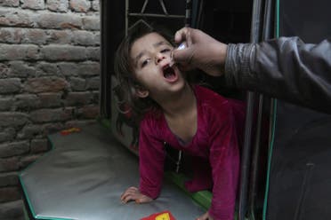 A health worker gives a polio vaccine to a child in Lahore, Pakistan, on Jan. 16, 2018. (AP)