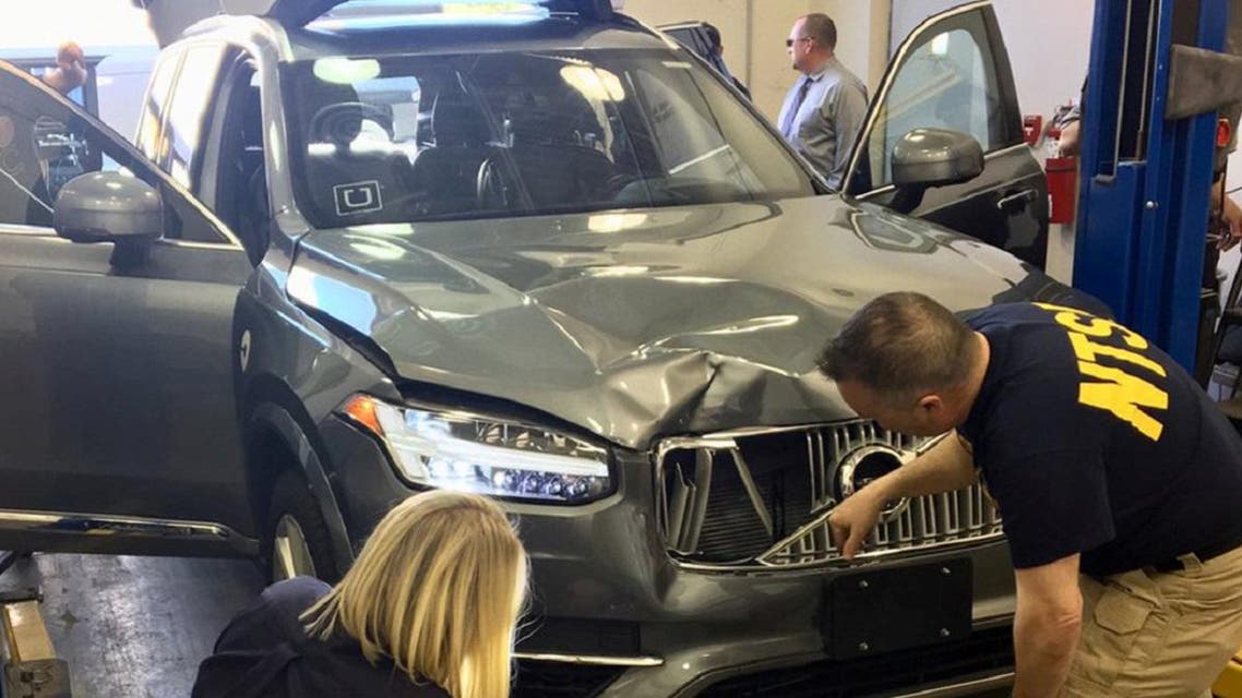 National Transportation Safety Board (NTSB) investigators examine a self-driving Uber vehicle involved in a fatal accident in Tempe, Arizona, on March 20, 2018. (Reuters)