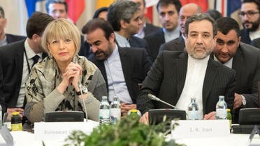 Abbas Araghchi (R), political deputy at the Ministry of Foreign Affairs of Iran, and the Secretary General of the European Union External Action Service (EEAS) Helga Schmid attend E3/EU+3 and Iran talks at Palais Coburg in Vienna, Austria on March 16, 2018. (AFP)