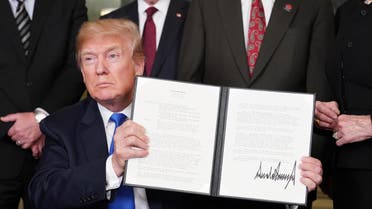 US President Donald Trump signs trade sanctions against China in the Diplomatic Reception Room of the White House in Washington, DC, on March 22, 2018.  (AFP)