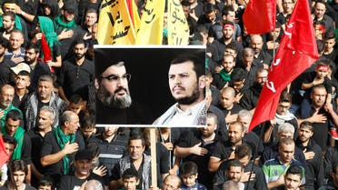 Supporters carry flags and a picture of Hassan Nasrallah and Yemen’s Houthi movement leader, Abdel Malek al-Houthi, in Beirut on October 12, 2016. (Reuters)