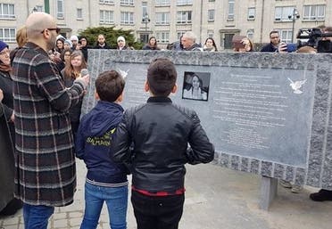 Mohamed el Bachiri and his sons in front of the stele inaugurated in Molenbeek on Wednesday 21 March 2018 in tribute to Loubna Lafquiri (Supplied)