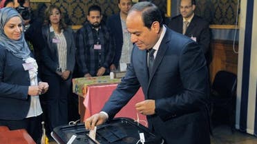 A handout picture released by the Egyptian Presidency on March 26, 2018 shows Egyptian President Abdel Fattah al-Sisi (C) casting his vote on the first day of the 2018 presidential elections at a polling station in the capital Cairo. (AFP)