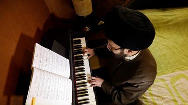 Shi'ite Muslim scholar Sayed Hussein al-Husseini, 38, plays the piano at his home in Dahieh. (Reuters)