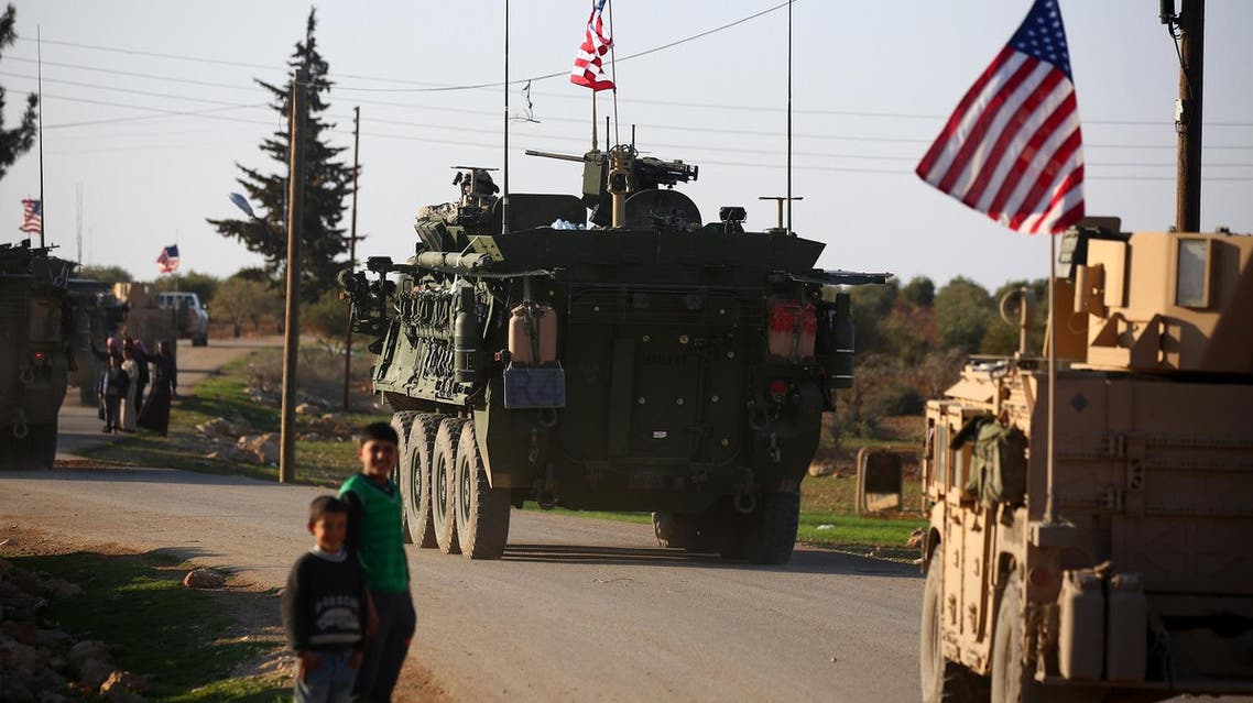 A convoy of US forces armored vehicles drives near the village of Yalanli, on the western outskirts of the northern Syrian city of Manbij. (AFP)