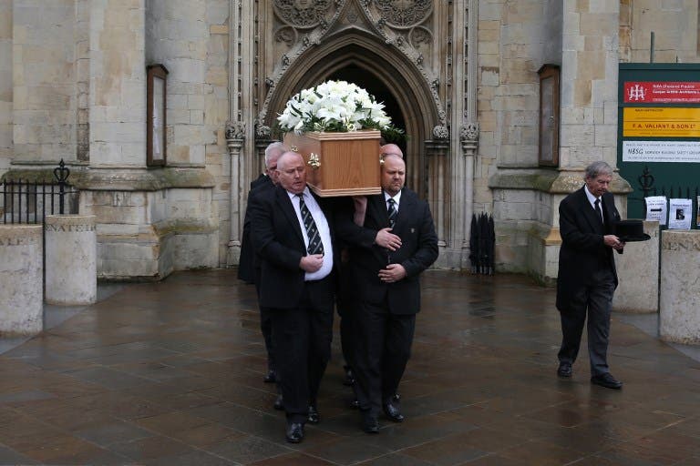 Six porters of Gonville & Caius College, act as pallbearers and carry the coffin of British scientist Stephen Hawking after the funeral service at the Church of St Mary the Great, in Cambridge on March 31, 2018. Friends, family and colleagues of British scientist Stephen Hawking gathered on March 31, 2018, to pay their respects at his private funeral in Cambridge, where he spent most of his extraordinary life. Daniel LEAL-OLIVAS / AFP