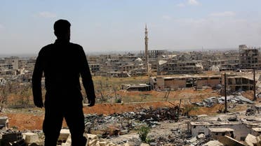 A Syrian soldier looks at destroyed buildings nearly a week after retaking the town of Harasta from the rebels, in Eastern Ghouta. (File photo: AFP)