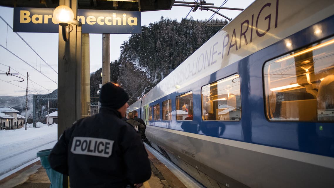 (FILES) In this file photo taken on January 12, 2018 French police officers board a TGV train coming from Milan and direct to Paris to control passengers at the Bardonecchia train station. Italy denounced on March 31, 2018 French border agents for allegedly entering the Italian train station facility of Bardonecchia to force a Nigerian migrant to give a urine sample for a drug test. The humanitarian group Rainbow4Africa, which helps migrants at the Bardonecchia crossing west of Turin, accused the five armed French border agents of entering the train station facility and intimidating its doctor, cultural mediators and lawyers on March 30, 2018 at night.  Piero CRUCIATTI / AFP