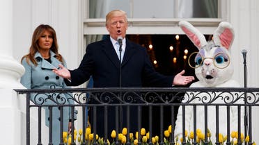 President Donald Trump, joined by the Easter Bunny and first lady Melania Trump speaks from the Truman Balcony of the White House in Washington, Monday, April 2, 2018, during the annual White House Easter Egg Roll. AP