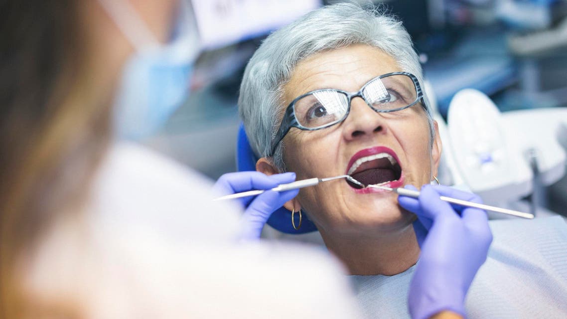 Senior female patient at dentist office - Stock image...