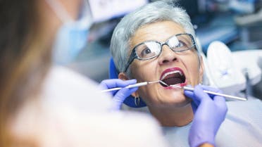 Senior female patient at dentist office - Stock image... 