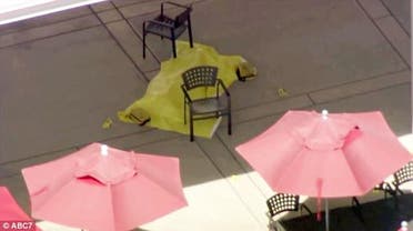 Authorities cover a body with a yellow tarp at YouTube's headquarters in the San Francisco Bay Area on Tuesday  