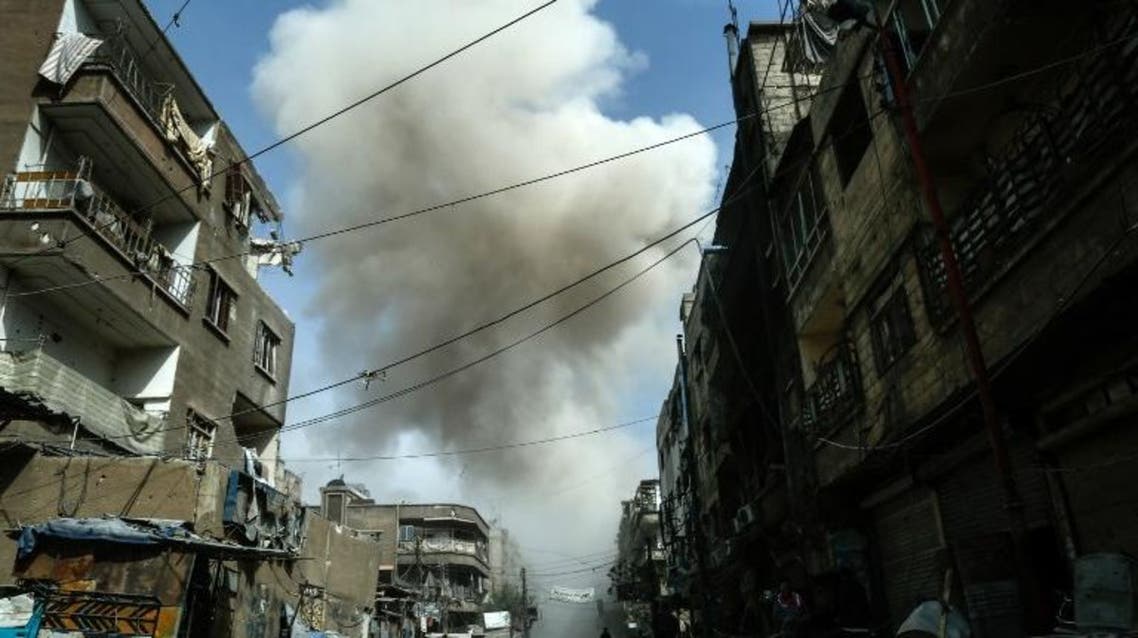 Smoke billows from buildings following a reported air strike on Douma, the main town of Syria's rebel enclave of Eastern Ghouta on March 20, 2018. HASAN MOHAMED / AFP