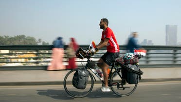 n this picture taken with low shutter speed, Mohammed Nufal, 24, rides his bicycle as he crosses Qasr El-Nile bridge, in Cairo, Egypt, Saturday, April 7, 2018. Nufal embarked on the long-haul journey Saturday planning to pedal crossing seven countries including Jordan, Bulgaria, Romania, Moldova and Ukraine, on his way to Russia in support to the Egyptian national team playing in World Cup, covering a distance of some 7,000 kilometers (4,350 miles). (AP Photo/Amr Nabil)