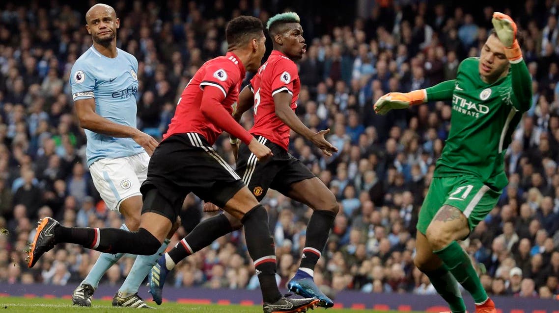 Manchester United’s Chris Smalling celebrates with Paul Pogba, (center right), after scoring his side’s third goal past Manchester City goalkeeper Ederson (right), during the English Premier League soccer match. (AP)